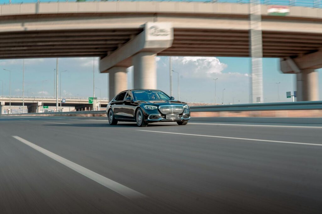 A car driving along the highway under a bridge A car driving under a bridge